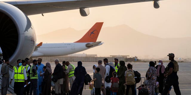 Foreigners board a Qatar Airways aircraft at the airport in Kabul, Afghanistan, Sept. 9, 2021.