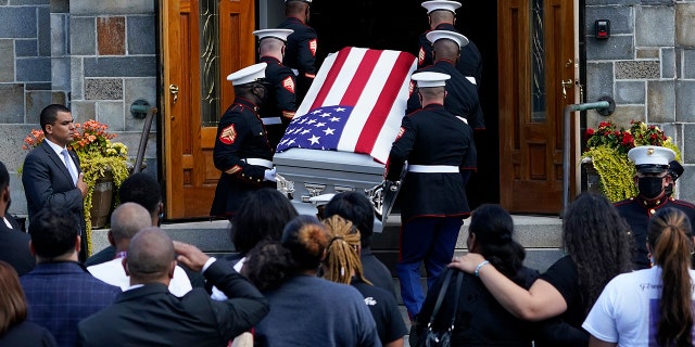 The casket of Sgt. Johanny Rosario Pichardo, a U.S. Marine who was among 13 service members killed in a suicide bombing in Afghanistan, is carried into the Farrah Funeral Home in her hometown of Lawrence, Mass, Saturday, Sept. 11, 2021.