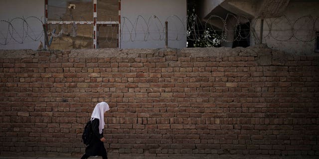 A girl walks to school before class in Kabul, Afghanistan, Sunday, Sept. 12, 2021.