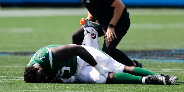 New York Jets offensive tackle Mekhi Becton is helped during the Panthers game on Sept. 12, 2021, in Charlotte, North Carolina.