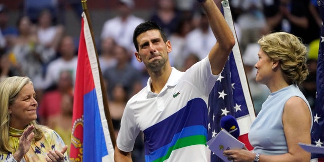 Novak Djokovic, of Serbia, center, waves to the crowd after losing to Daniil Medvedev, of Russia, in the men's singles final of the US Open tennis championships, Sunday, Sept. 12, 2021, in New York.