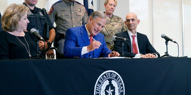 Texas Gov. Abbott Touts Border Security In Major Ad Blitz Ahead Of GOP Primary - Fox News 2 Texas Gov Greg Abbott, front center, is flanked by officials as he signs a bill that provides additional funding for security at the U.S.-Mexico border on Sept. 17, 2021.