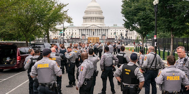 Police stage at a security fence ahead of a rally near the U.S. Capitol in Washington, Saturday, Sept. 18, 2021.
