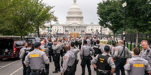 Police stage at a security fence ahead of a rally near the U.S. Capitol in Washington, Saturday, Sept. 18, 2021.