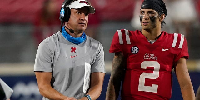 Mississippi head coach Lane Kiffin confers with quarterback Matt Corral (2) during the second half of the team's NCAA college football game against Tulane on Saturday, Sept. 18, 2021, in Oxford, Miss. Mississippi won 61-21.