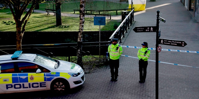 FILE - In this Wednesday, March 7, 2018 file photo, police officers guard a cordon around a police tent covering the the spot where former Russian double agent Sergei Skripal and his daughter were found critically ill.