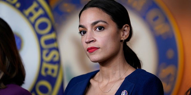  In this June 16, 2021, file photo US Rep. Alexandria Ocasio-Cortez, DN.Y., listens as House Speaker Nancy Pelosi, D-Calif., speaks during a news conference at the Capitol in Washington.