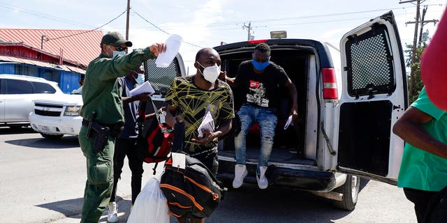 Migrants are released from United States Border Patrol custody at a humanitarian center, Wednesday, Sept. 22, 2021, in Del Rio, Texas. (AP Photo/Julio Cortez)