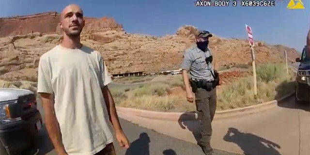 FILE - This Aug. 12, 2021 file photo from video provided by The Moab Police Department shows Brian Laundrie talking to a police officer after police pulled over the van he was traveling in with his girlfriend, Gabrielle "Gabby" Petito, near the entrance to Arches National Park. Laundrie, the boyfriend of Gabby Petito, whose body was found at a national park in Wyoming after a cross-country trip with him, has been charged with unauthorized use of a debit card as searchers continue looking for him in Florida swampland, federal authorities announced Thursday, Sept. 23, 2021. (The Moab Police Department via AP, File)
