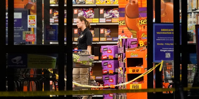 A responder walks down an aisle in a Kroger grocery store as the investigation goes into the night following a shooting earlier in the day on Thursday, Sept. 23, 2021, in Collierville, Tenn. (AP Photo/Mark Humphrey)