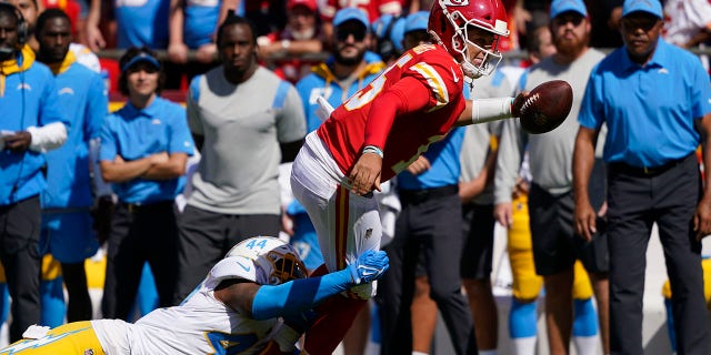 Kansas City Chiefs quarterback Patrick Mahomes (15) is tackled by Los Angeles Chargers' Kyzir White (44) during the first half of an NFL football game, Sunday, Sept. 26, 2021, in Kansas City, Mo.