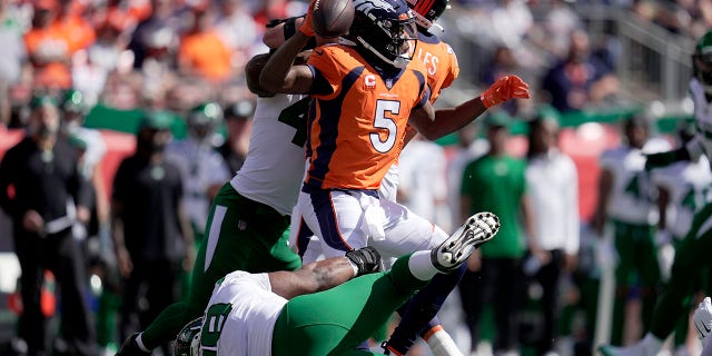 New York Jets defensive tackle Sheldon Rankins tackles Denver Broncos quarterback Teddy Bridgewater (5) during the first half of an NFL football game Sunday, Sept. 26, 2021, in Denver. (AP Photo/Jack Dempsey)
