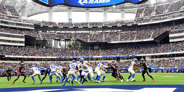 Los Angeles Rams quarterback Matthew Stafford (9) hands off to running back Sony Michel (25) during the first half of an NFL football game Sunday, Sept. 26, 2021, in Inglewood, Calif. (AP Photo/Kevork Djansezian)