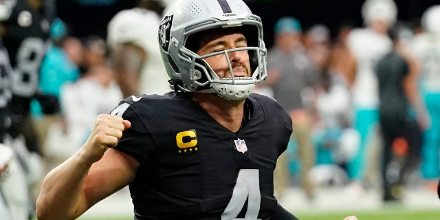 Las Vegas Raiders quarterback Derek Carr (4) celebrates after wide receiver Hunter Renfrow scored a touchdown against the Miami Dolphins during the second half of an NFL football game, Sunday, Sept. 26, 2021, in Las Vegas. (AP Photo/Rick Scuteri)