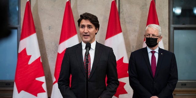 In this Sept. 24, 2021, file photo, Prime Minister Justin Trudeau stands with Minister of Foreign Affairs Marc Garneau to announce that Canadians Michael Spavor and Michael Kovrig have been released from detention in China, on Parliament Hill in Ottawa. China's Foreign Ministry said Monday, Sept. 27, 2021, that the two Canadians were released on bail for health reasons.