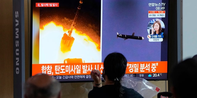 People watch a TV showing a file image of North Korea's missiles launch during a news program at the Seoul Railway Station in Seoul, South Korea, Tuesday, Sept. 28, 2021. (AP Photo/Ahn Young-joon)