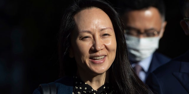 In this Sept. 24, 2021, file photo, Meng Wanzhou, chief financial officer of Huawei, smiles as she leaves her home in Vancouver. A pair of American siblings, Cynthia and Victor Liu, have returned to the U.S. on Sunday, Sept. 26, 2021, after China lifted an exit ban following Canada’s release of Meng wanted in the U.S. on fraud charges.