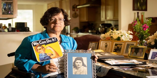 Sept 27, 2021: Dorene Giacopini holds up a photo of her mother Primetta Giacopini while posing for a photo at her home in Richmond, Calif.  