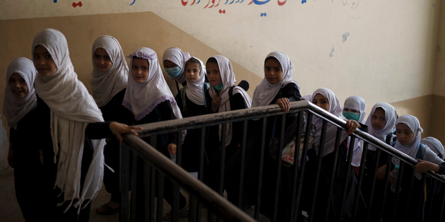 Girls climb the stairs as they enter a pre-school school in Kabul, Afghanistan on Sunday, September 12, 2021.