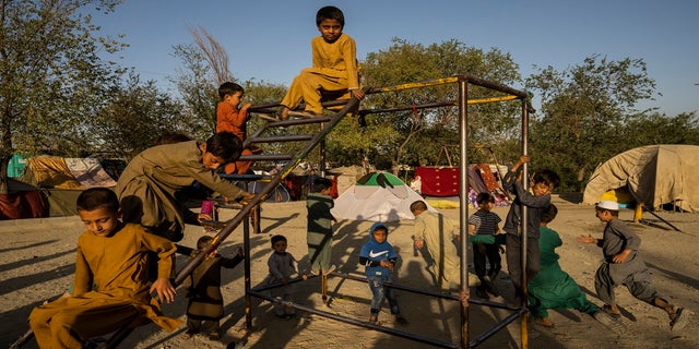 Afghan displaced children play at an internally displaced persons camp in Kabul, Afghanistan, on Monday.