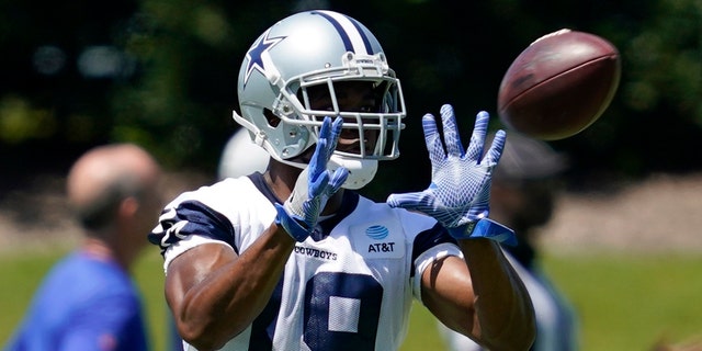 Dallas Cowboys wide receiver Amari Cooper reaches out to catch a pass during a workout at the team's NFL football training facility in Frisco, Texas, Wednesday, Aug. 25, 2021. (AP Photo/Tony Gutierrez)