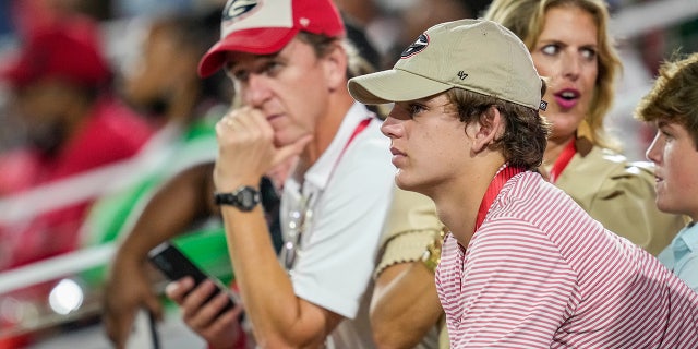 High school player Arch Manning looks on with his parents during a game between the South Carolina Gamecocks against the Georgia Bulldogs Sept. 18, 2021, at Sanford Stadium. 