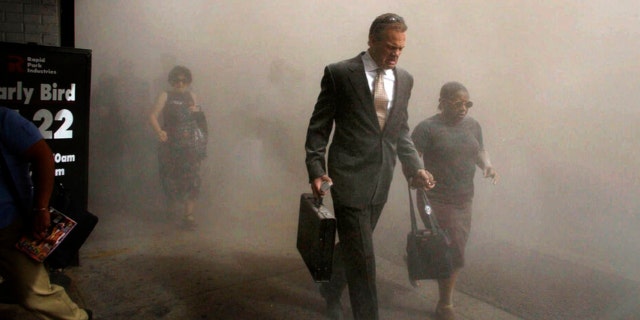 Pedestrians flee the area of  New York’s World Trade Center in lower Manhattan on Tuesday, Sept. 11, 2001. 