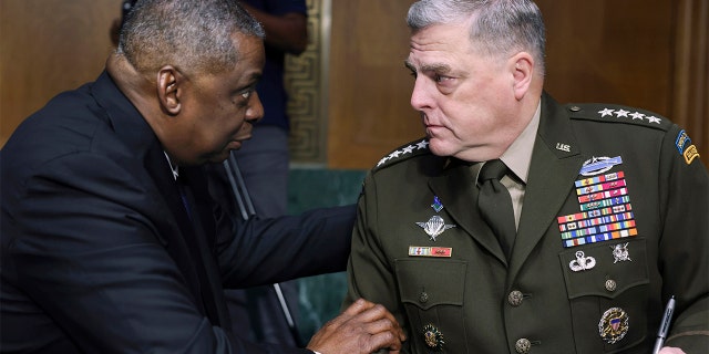 In this June 17, 2021, file photo, Secretary of Defense Lloyd Austin, left, and Chairman of the Joint Chiefs Chairman Gen. Mark Milley talk before a Senate Appropriations Committee hearing on Capitol Hill in Washington. (Evelyn Hockstein/Pool via AP)