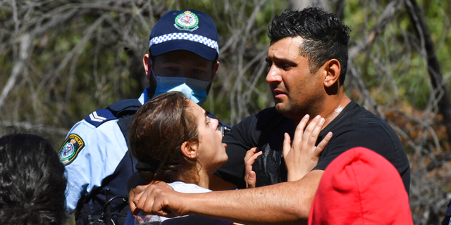 Anthony Elfalak, right, and his wife, Kelly, embrace after hearing their son AJ is found alive on the family property near Putty, north west of Sydney, Australia, Monday, Sept. 6, 2021.