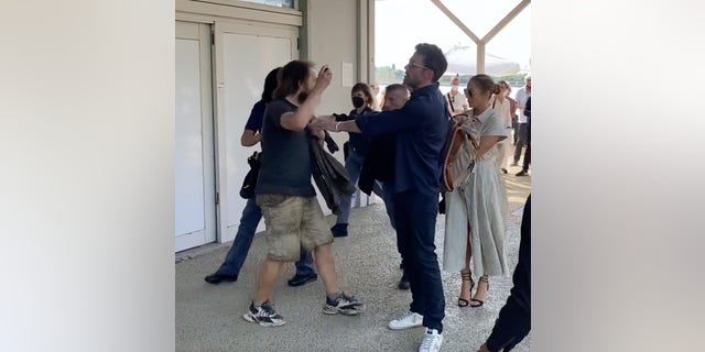 Ben Affleck held back a fan who tried to get a selfie with Jennifer Lopez before their bodyguard stepped in.