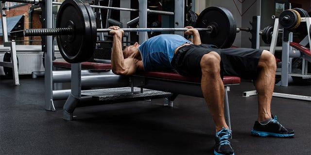 Man during bench press exercise in gym