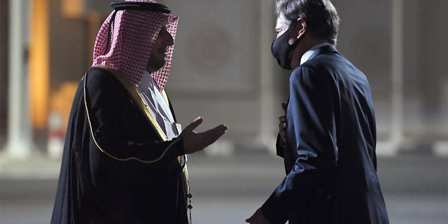 U.S. Secretary of State Antony Blinken, right, is welcomed upon his arrival by MFA Director of Protocol Ambassador Ibrahim Fakhroo at Old Doha Airport in Qatar's capital Monday, Sept. 6, 2021.