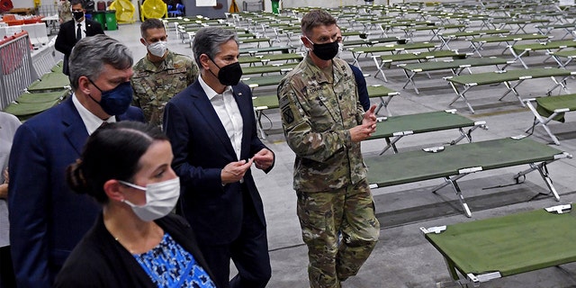 Secretary of State Antony Blinken, center, tours a processing center for Afghan evacuees at al-Udeid Air Base, in Doha, Qatar, Tuesday, Sept. 7, 2021. (Olivier Douliery/Pool Photo via AP)