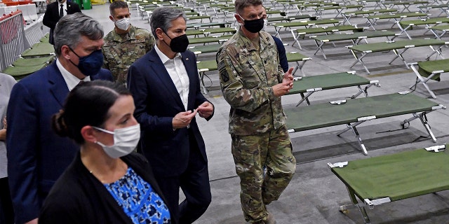 Secretary of State Antony Blinken, center, tours a processing center for Afghan evacuees at al-Udeid Air Base, in Doha, Qatar, Tuesday, Sept. 7, 2021. (Olivier Douliery/Pool Photo via AP)