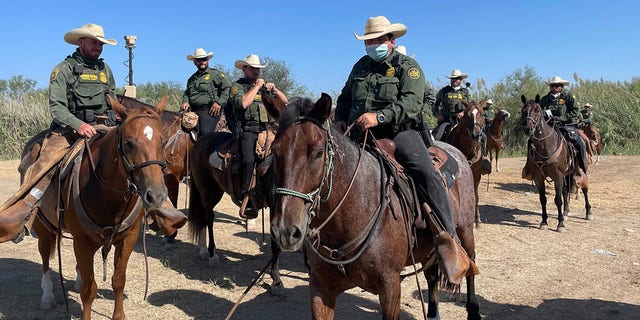 Border Patrol agents on horseback. 