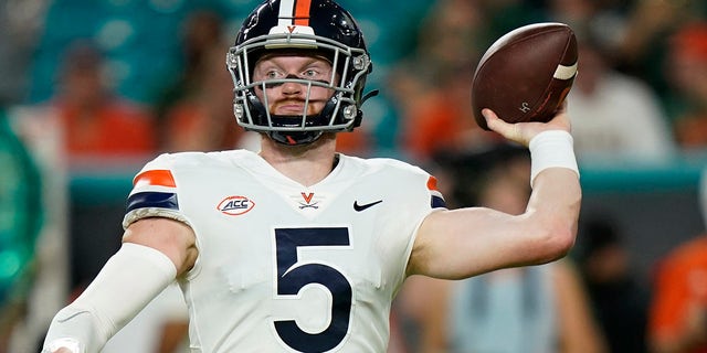 Virginia Cavaliers quarterback Brennan Armstrong (5) aims for a pass during the first half of an NCAA college football game against the Miami Hurricanes on Thursday, September 30, 2021, in Miami Gardens, Fla.