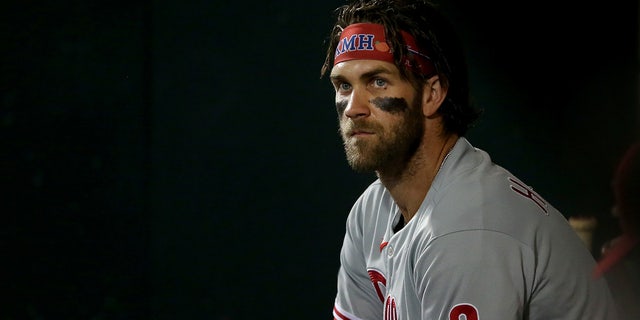 Philadelphia Phillies right fielder Bryce Harper watches from the dugout during the third inning against the New York Mets at Citi Field.