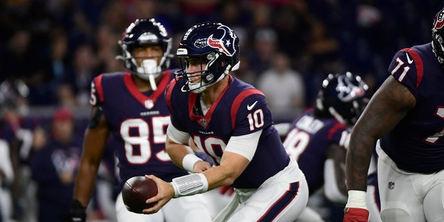 Houston Texans quarterback Davis Mills (10) looks to hand the ball off during the first half of an NFL football game against the Carolina Panthers Thursday, Sept. 23, 2021, in Houston.