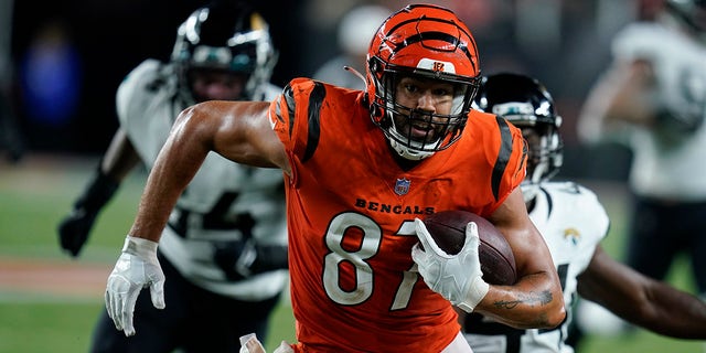Cincinnati Bengals' C.J. Uzomah (87) goes in for a touchdown during the second half of an NFL football game against the Jacksonville Jaguars, Thursday, Sept. 30, 2021, in Cincinnati.