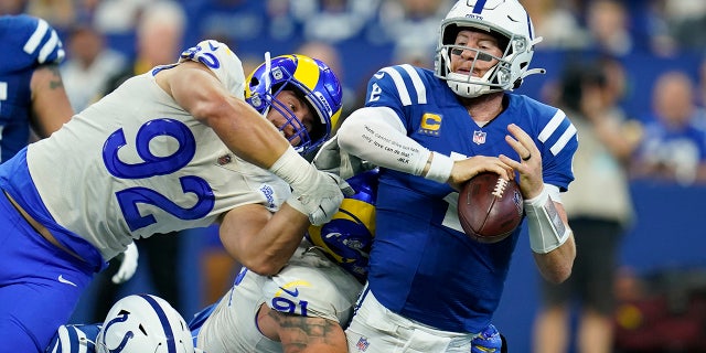Indianapolis Colts quarterback Carson Wentz (2) is sacked by Los Angeles Ram Greg Gaines (91) during the first half of an NFL football game, Sunday, Sept. 19, 2021, in Indianapolis.