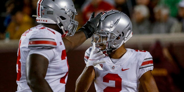 Ohio State wide receiver Chris Olave (2) celebrates his touchdown catch against Minnesota with tackle Nicholas Petit-Frere (78) during the third quarter of an NCAA college football game Thursday, Sept. 2, 2021, in Minneapolis. Ohio State won 45-31. 