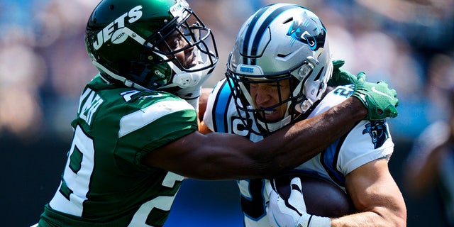 Carolina Panthers running back Christian McCaffrey is tackled by New York Jets free safety Lamarcus Joyner during the first half of an NFL football game Sunday, Sept. 12, 2021, in Charlotte, N.C. 