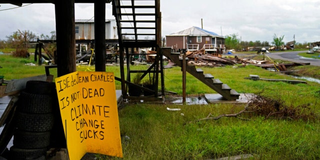 Storm clouds from Tropical Storm Nicholas are seen behind homes of the vanishing Native American community of Isle de Jean Charles, La., which were destroyed by Hurricane Ida, Tuesday, Sept. 14, 2021.