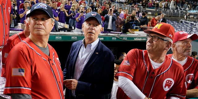 President Joe Biden visits the Republican dugout as he attends the Congressional Baseball Game at Nationals Park, Sept. 29, 2021, in Washington.