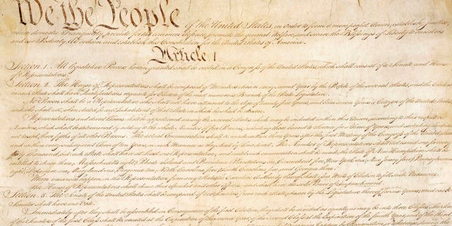 This photo made available by the U.S. National Archives shows a portion of the first page of the United States Constitution. (National Archives via AP)