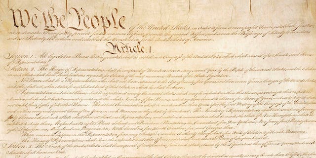 This photo made available by the U.S. National Archives shows a portion of the first page of the United States Constitution. (National Archives via AP)