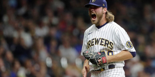 Milwaukee Brewers' Corbin Burnes reacts after striking out a batter during the seventh inning of a baseball game against the New York Mets Saturday, Sept. 25, 2021, in Milwaukee.