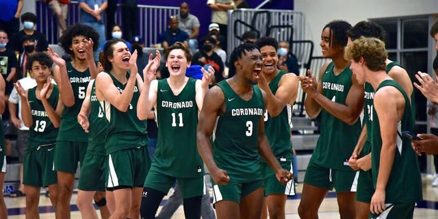 Coronado Islanders Varsity Basketball team celebrates their CIF Championship on the court after buzzer goes off in their 51-48 win over Orange Glen Friday, June 11, 2021 in San Diego. (Photo by Joan C . Fahrenthold).