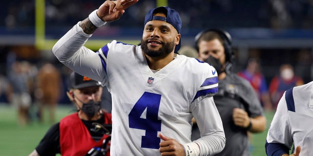 Dallas Cowboys quarterback Dak Prescott (4) acknowledges fans as he jogs off the field after their NFL football game against the Philadelphia Eagles in Arlington, Texas, Monday, Sept. 27, 2021.