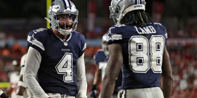 Dallas Cowboys quarterback Dak Prescott (4) celebrates with wide receiver CeeDee Lamb (88) after a touchdown against the Tampa Bay Buccaneers during the first half Sept. 9, 2021, in Tampa, Fla.